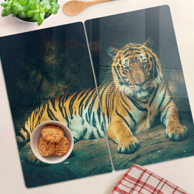Glass kitchen board Tiger lying on the rocks