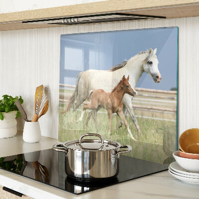 Glass kitchen board A horse with a foal in a meadow
