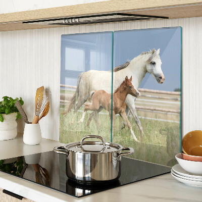 Glass kitchen board A horse with a foal in a meadow