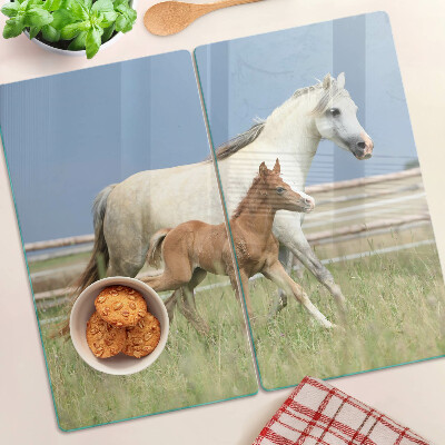 Glass kitchen board A horse with a foal in a meadow