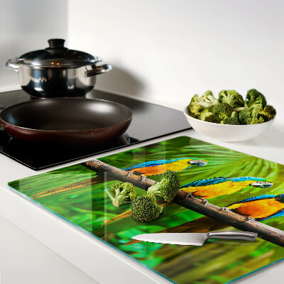 Glass kitchen board Parrots on a branch in the tropics