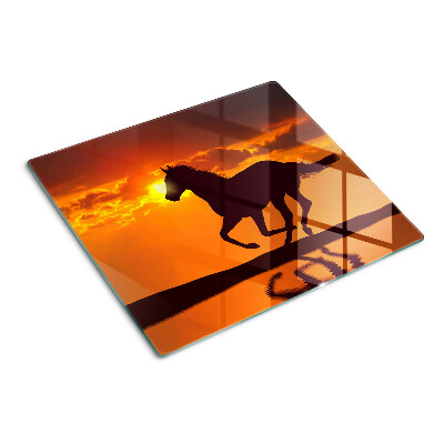 Glass chopping board A horse against the backdrop of the setting sun