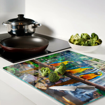 Glass chopping board Parrots on a branch in a tropical forest