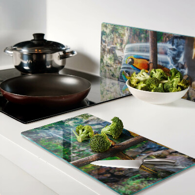 Glass chopping board Parrots on a branch in a tropical forest