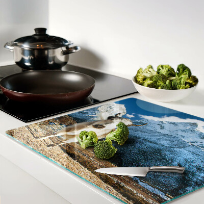 Glass kitchen board Cow in the mountains