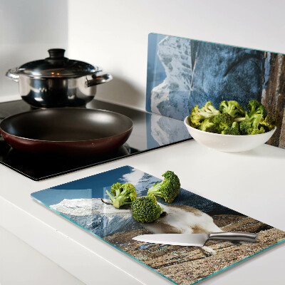 Glass kitchen board Cow in the mountains