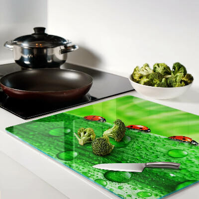 Glass chopping board Ladybugs on a green background