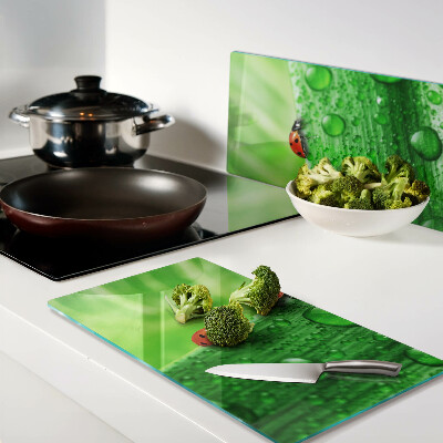 Glass chopping board Ladybugs on a green background