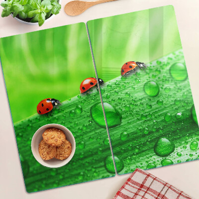 Glass chopping board Ladybugs on a green background