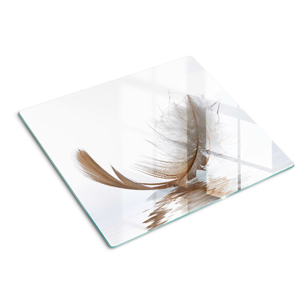 Glass chopping board Feather on the water background