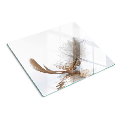 Glass chopping board Feather on the water background