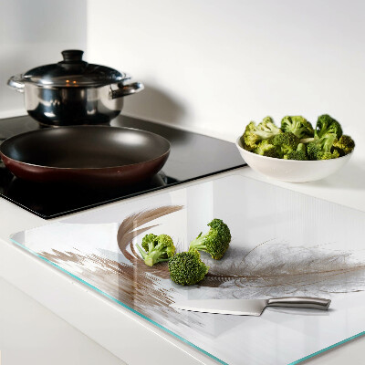 Glass chopping board Feather on the water background
