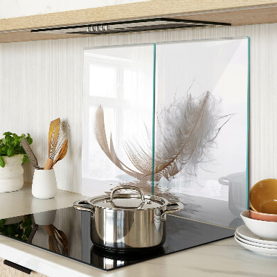Glass chopping board Feather on the water background
