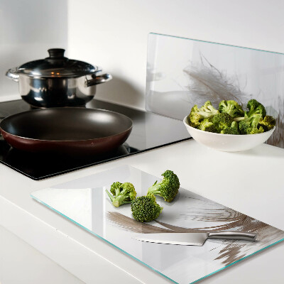 Glass chopping board Feather on the water background