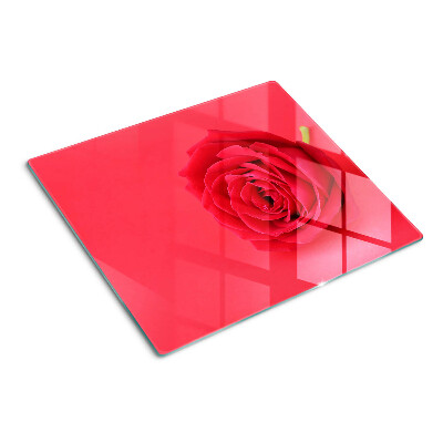 Glass chopping board Red rose on the background
