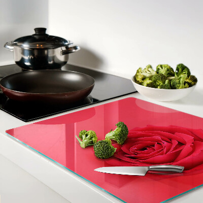 Glass chopping board Red rose on the background