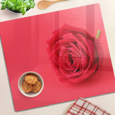 Glass chopping board Red rose on the background