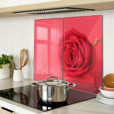 Glass chopping board Red rose on the background