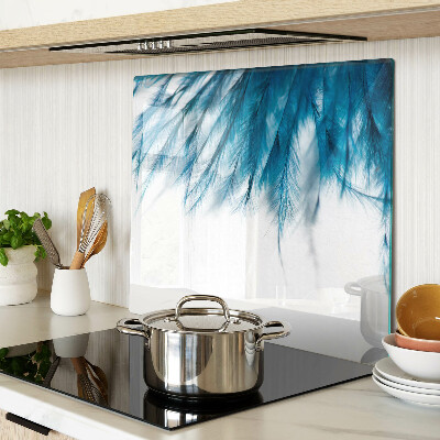 Glass kitchen board Blue feathers on white background