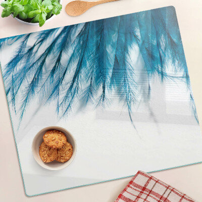 Glass kitchen board Blue feathers on white background