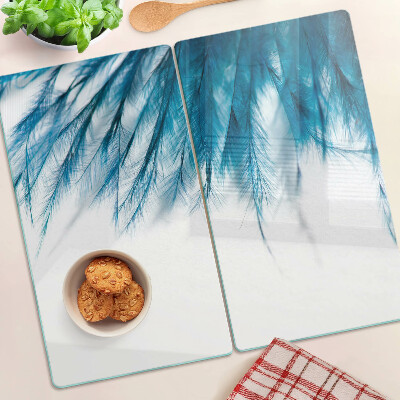 Glass kitchen board Blue feathers on white background