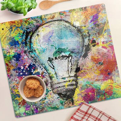 Glass kitchen board Light bulb on a colored background