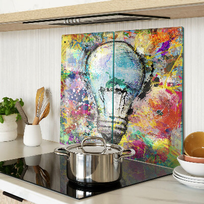 Glass kitchen board Light bulb on a colored background
