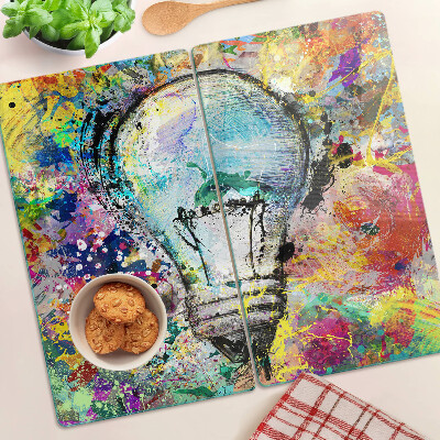 Glass kitchen board Light bulb on a colored background