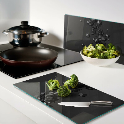 Glass kitchen board Black crystals on the background