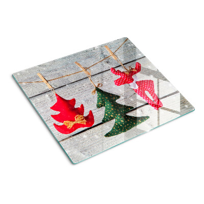 Glass chopping board Christmas decorations on a wooden background