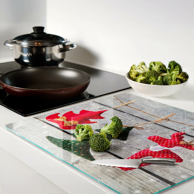 Glass chopping board Christmas decorations on a wooden background