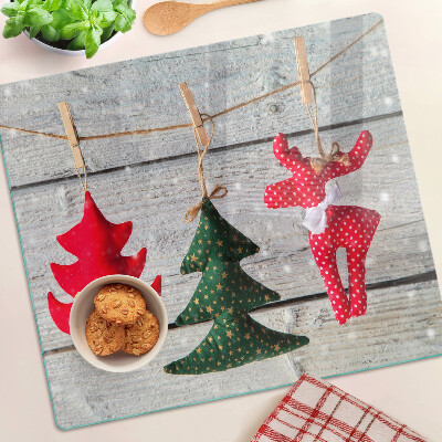 Glass chopping board Christmas decorations on a wooden background