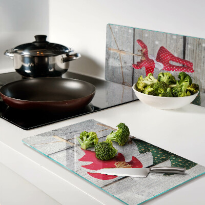 Glass chopping board Christmas decorations on a wooden background