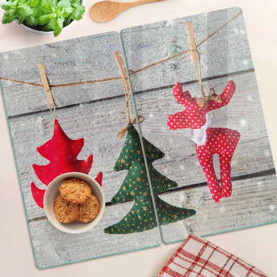 Glass chopping board Christmas decorations on a wooden background
