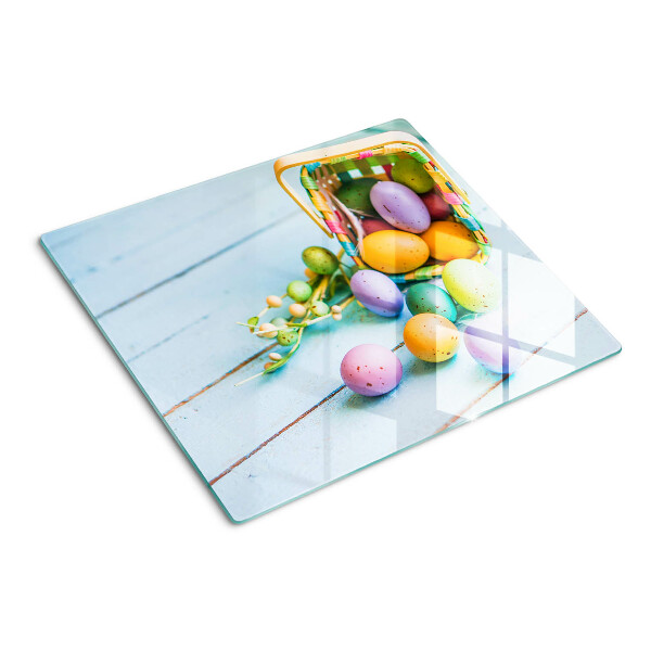 Glass kitchen board Easter colored eggs in a basket