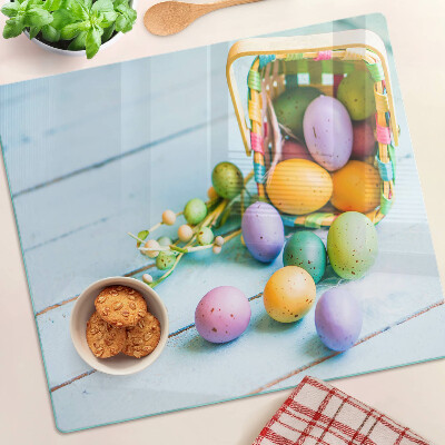 Glass kitchen board Easter colored eggs in a basket