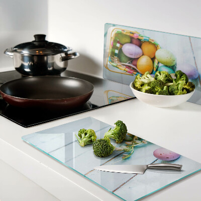 Glass kitchen board Easter colored eggs in a basket