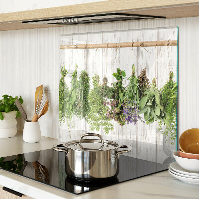 Glass chopping board Herbs on a wooden background