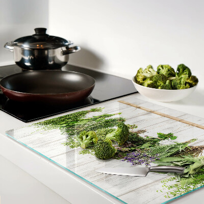 Glass chopping board Herbs on a wooden background