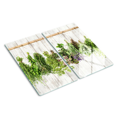 Glass chopping board Herbs on a wooden background