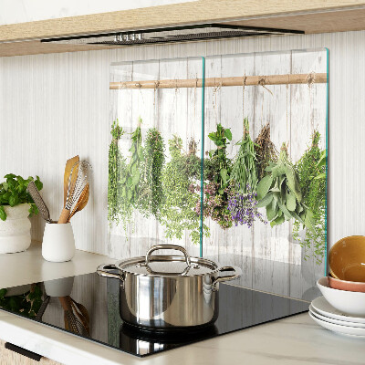 Glass chopping board Herbs on a wooden background
