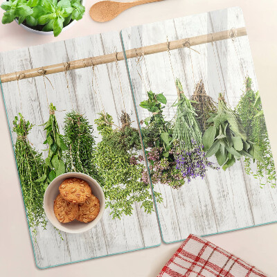 Glass chopping board Herbs on a wooden background