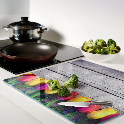 Glass chopping board Tulips on a wooden background