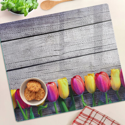Glass chopping board Tulips on a wooden background