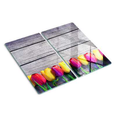 Glass chopping board Tulips on a wooden background