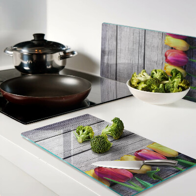 Glass chopping board Tulips on a wooden background