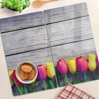 Glass chopping board Tulips on a wooden background
