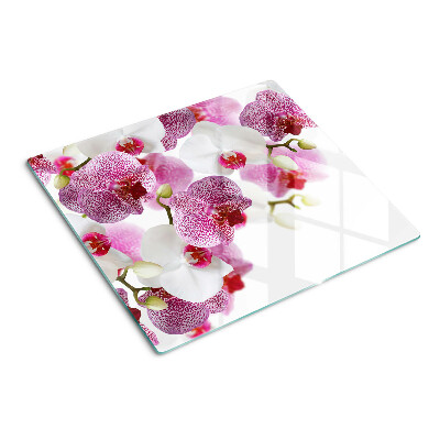 Glass chopping board Orchids in front of the window
