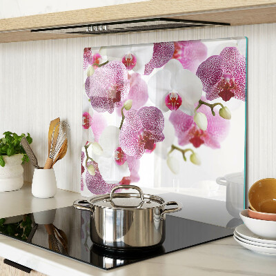 Glass chopping board Orchids in front of the window