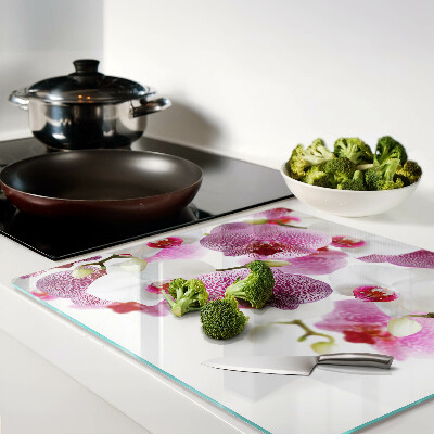 Glass chopping board Orchids in front of the window
